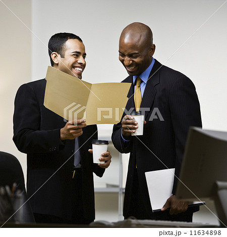 Multi-ethnic businessman laughing at paperwork 11634898