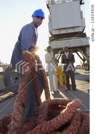 African American manual worker pulling rope African American manual worker pulling rope 11634936