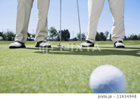 Golf ball with golfers in background 11634948