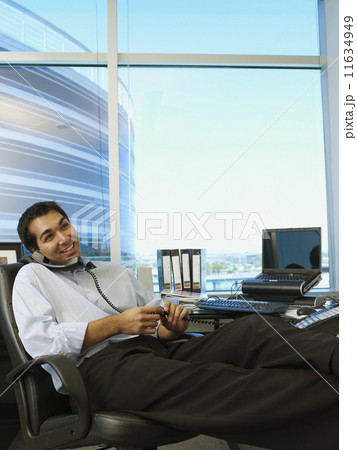 Hispanic businessman talking on telephone 11634949