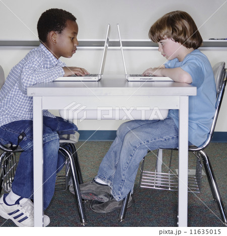 Two boys working on laptops Two boys working on laptops 11635015