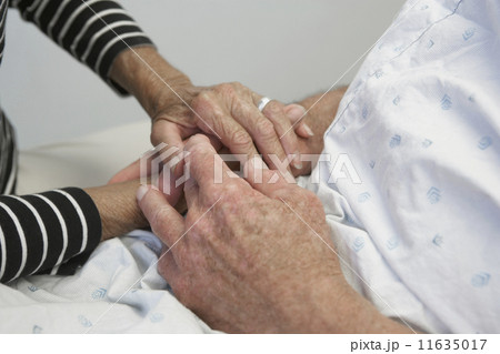 Close up of senior couple holding hands in hospital Close up of senior couple holding hands in hospital 11635017