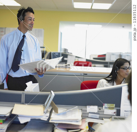 Businessman and woman working in office Businessman and woman working in office 11635112