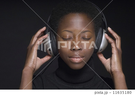 Portrait of African woman wearing headphones Portrait of African woman wearing headphones 11635180
