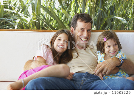 Hispanic father and daughters hugging 11635229