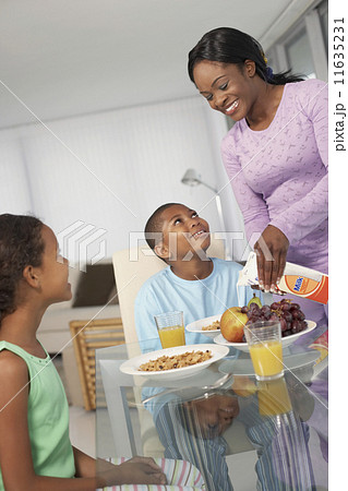 African American mother and children at breakfast 11635231