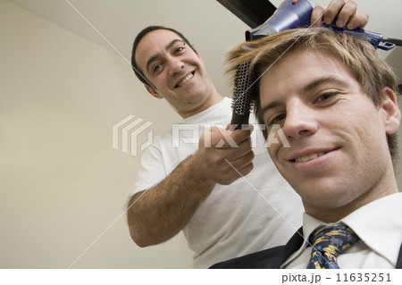Male hair stylist working on male client 11635251