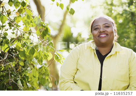 African woman smiling in woods 11635257