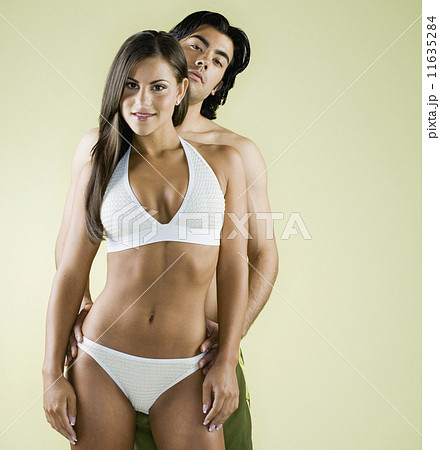 Multi-ethnic couple wearing bathing suits Multi-ethnic couple wearing bathing suits 11635284