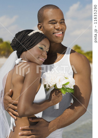 African bride and groom hugging 11635290