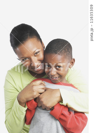 Studio shot of African mother hugging her young son  11635309