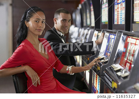 Hispanic couple at slot machines Hispanic couple at slot machines 11635327