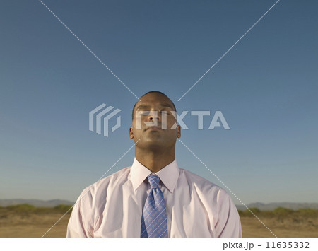 African businessman with eye closed 11635332