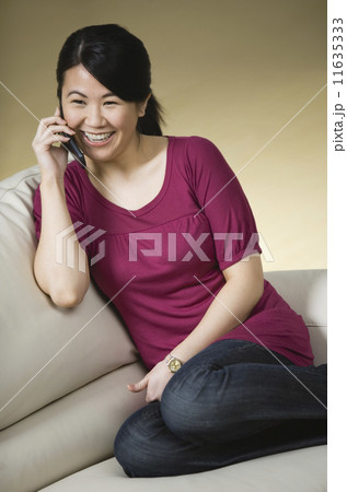 Asian woman talking on cell phone 11635333