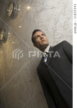 Low angle view of Hispanic businessman Low angle view of Hispanic businessman 11635341