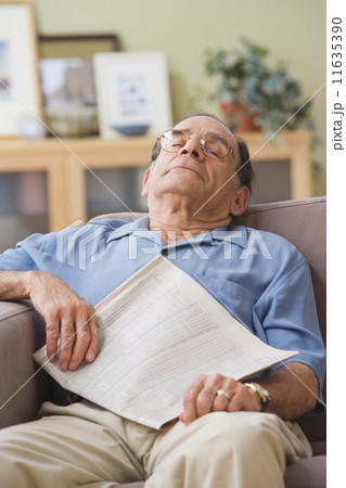 Senior Hispanic man sleeping on sofa 11635390