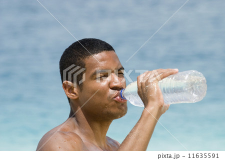 Hispanic man drinking water bottle 11635591