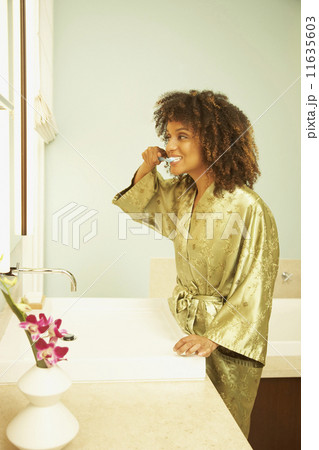 African American woman brushing teeth 11635603