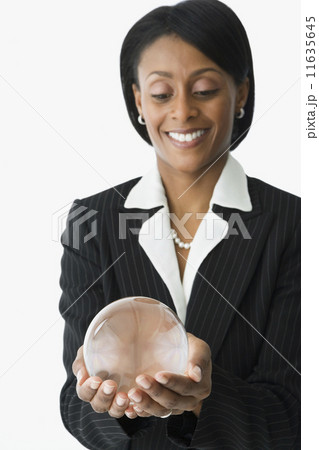 African businesswoman holding crystal ball 11635645