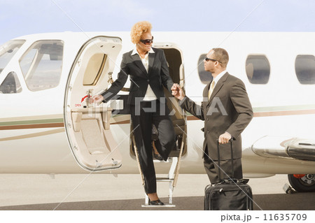 African American businesswoman getting off airplane 11635709