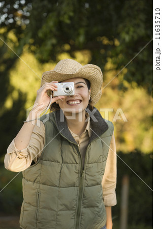 Asian woman taking photograph 11635710
