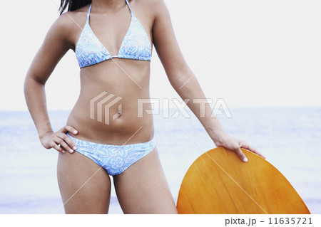 Young woman leaning on boogie board Young woman leaning on boogie board 11635721