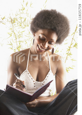 Woman writing in journal  11635759