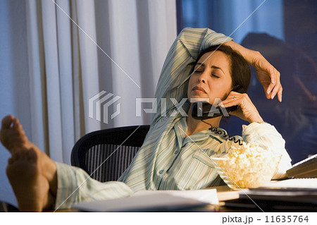 Hispanic businesswoman working in pajamas 11635764