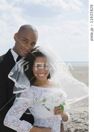 Multi-ethnic bride and groom hugging 11635826