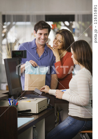 Hispanic couple shopping in clothing store 11635891