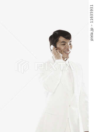 Asian businessman talking on cell phone 11635931