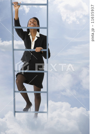 African businesswoman climbing ladder in clouds 11635937