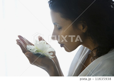 Indian woman smelling flower 11635938