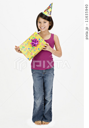 Studio shot of Asian girl with gift and party hat 11635940