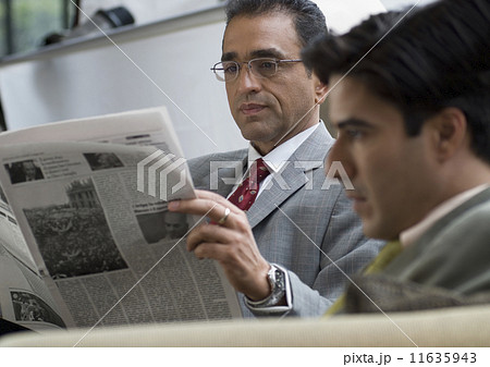 Hispanic businessman reading newspaper 11635943