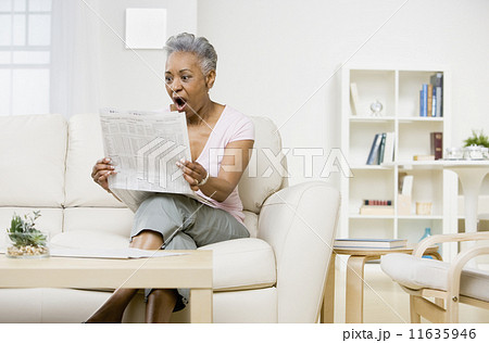 Senior African American woman reading newspaper Senior African American woman reading newspaper 11635946