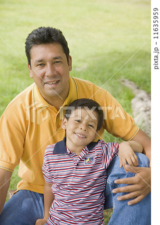 Hispanic father and son outdoors 11635959