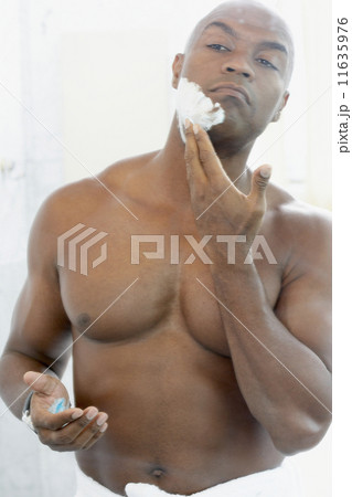 African American man applying shaving cream African American man applying shaving cream 11635976