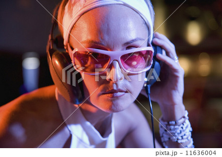 Hispanic woman wearing headphones 11636004