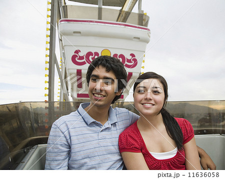 Multi-ethnic teenaged couple on carnival ride 11636058
