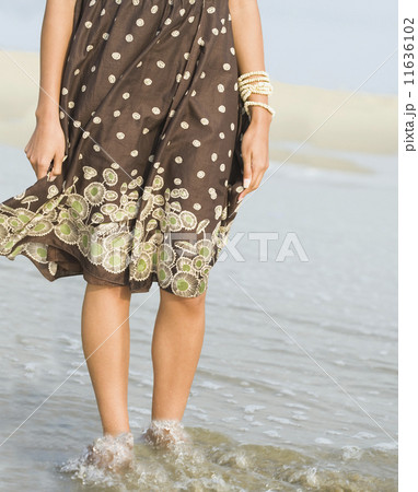 African woman wading in ocean surf African woman wading in ocean surf 11636102