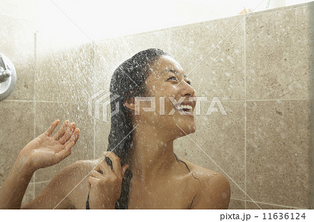 Asian woman laughing in shower 11636124