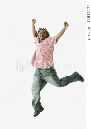 Studio shot of African man jumping Studio shot of African man jumping 11636174