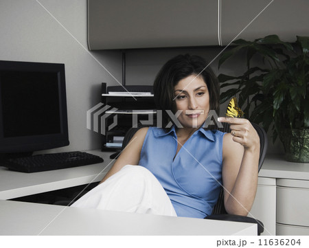 Hispanic businesswoman with butterfly on finger 11636204