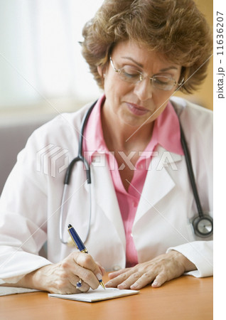Female doctor writing prescription 11636207