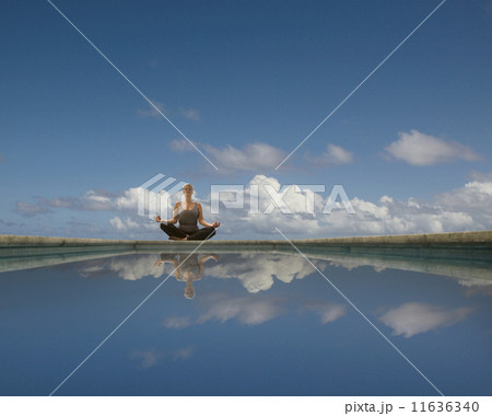 Hispanic woman meditating Hispanic woman meditating 11636340