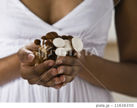 African American woman holding mushrooms African American woman holding mushrooms 11636350