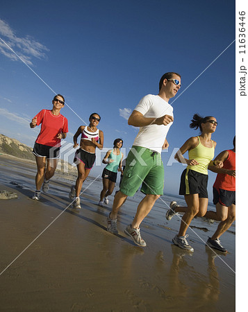 Multi-ethnic runners racing at beach Multi-ethnic runners racing at beach 11636446
