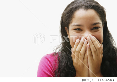 Portrait of African woman covering mouth Portrait of African woman covering mouth 11636563