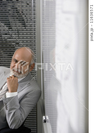 Senior African businessman next to whiteboard 11636571
